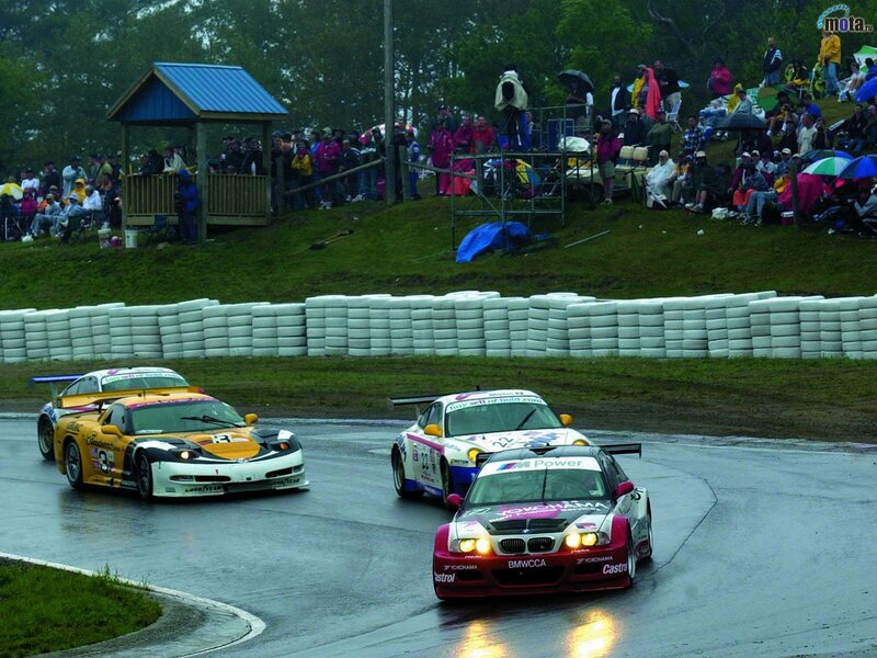 Race cars on wet track