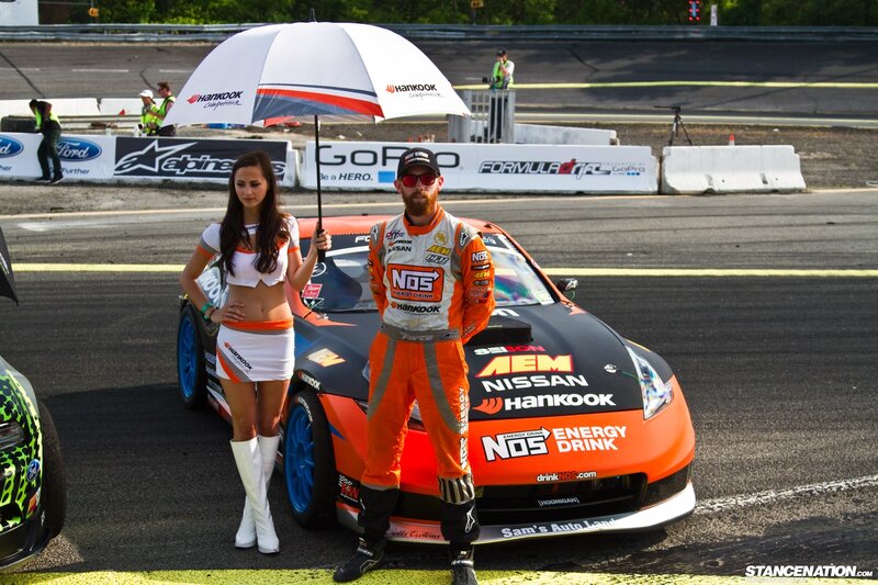 Racer and grid girl at track