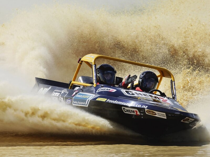 Racing Boat on Water — Blue, Dynamic, Afternoon, Photograph, People, Helmets