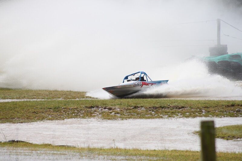 Racing Boat on Wet Grass
