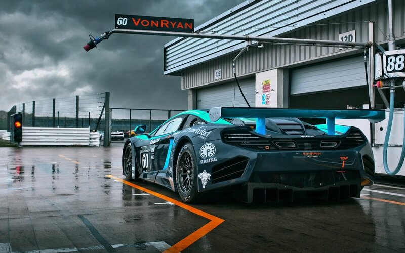 Racing Car in Pit Lane — Black, Dramatic, Photograph