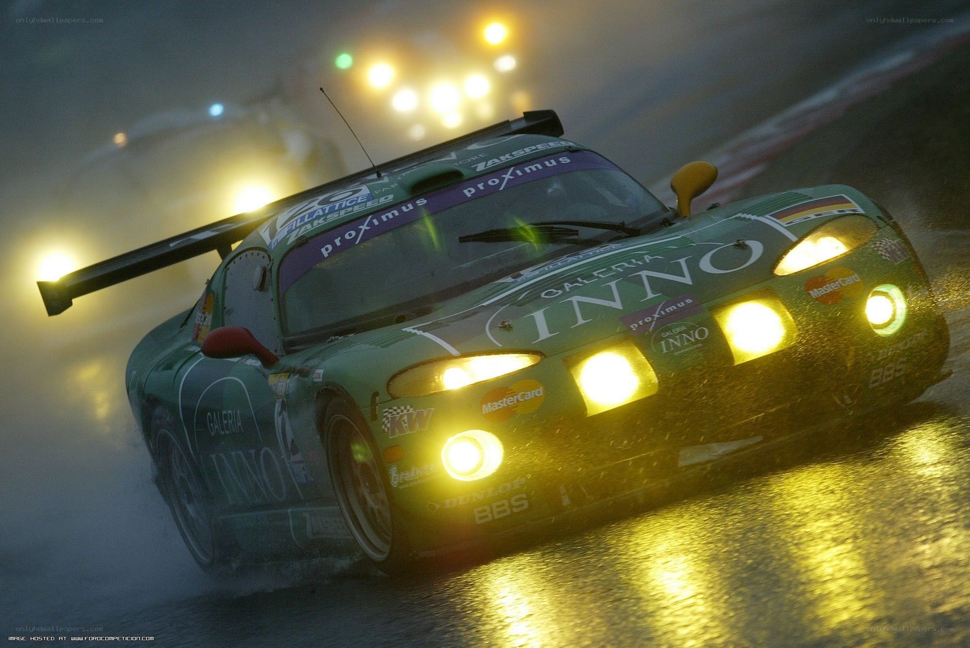 racing car in rain at night