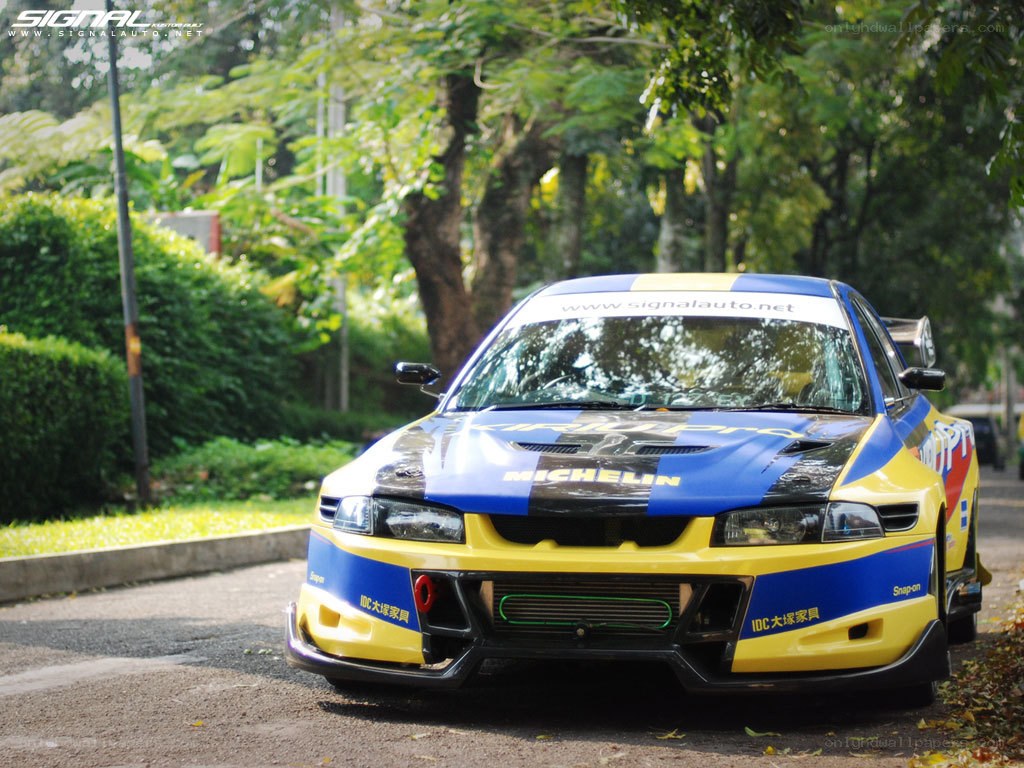racing car on a tree-lined road
