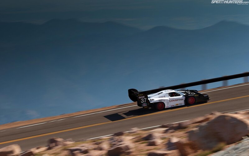Racing Car on Mountain Road — White, Dramatic