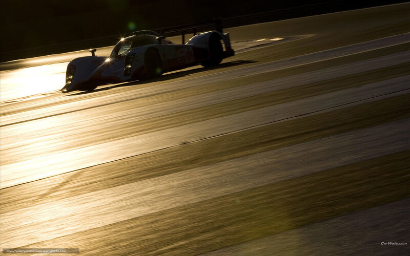 racing car on track at sunset