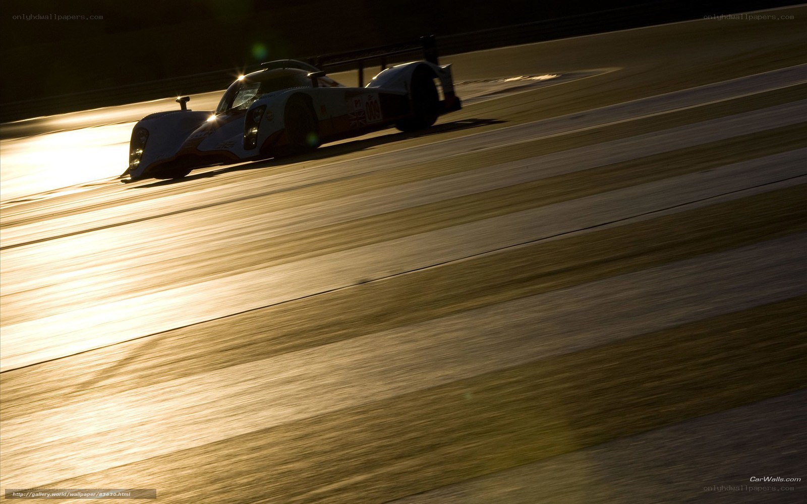 racing car on track at sunset