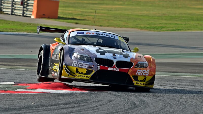 Racing Car on Track — Black, Dynamic, Afternoon, Photograph, Race Car, Grass