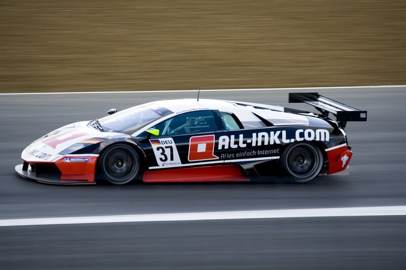 Racing Car on Track — Black, Dynamic, Afternoon, Photograph, Race Car, Sponsor Logo