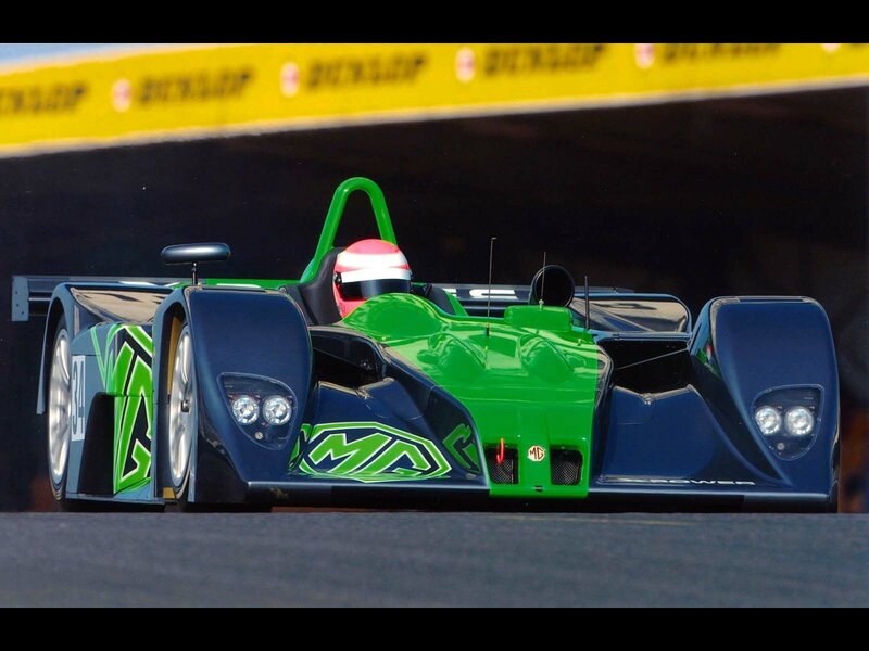 Racing Car on Track — Green, Dynamic, Afternoon, Photograph, Driver, Race Car