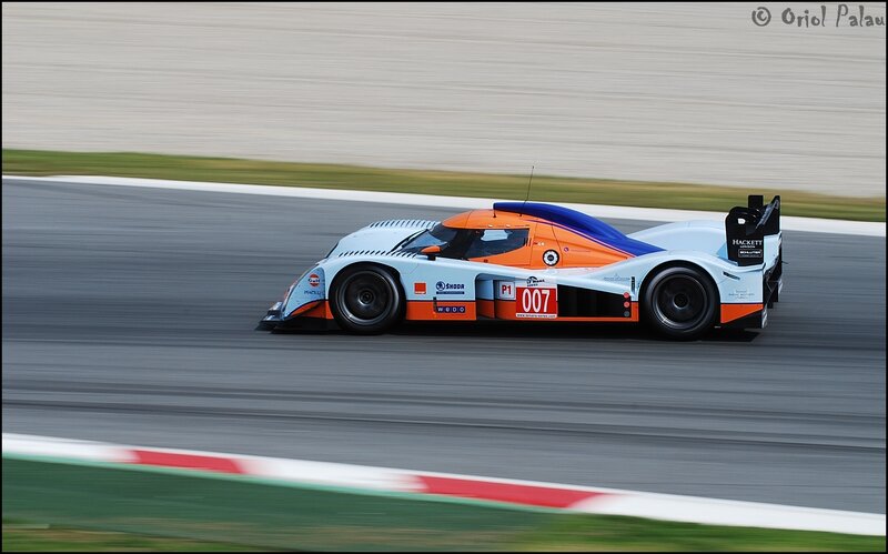 Racing Car on Track — White, Dynamic, Afternoon, Photograph, Race Car, Grass, Orange