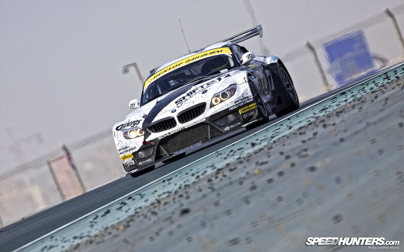 Racing Car on Track — White, Dynamic, Photograph, Race Car, Fence