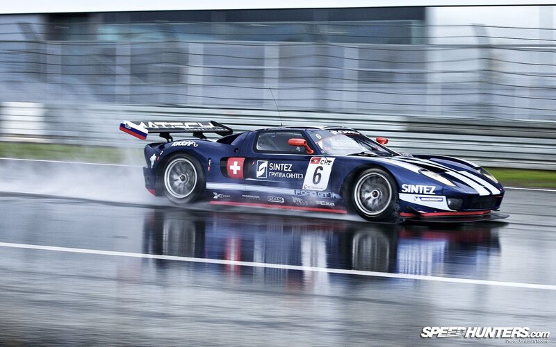 Racing Car on Wet Track — Blue, Dynamic, Photograph, Race Car