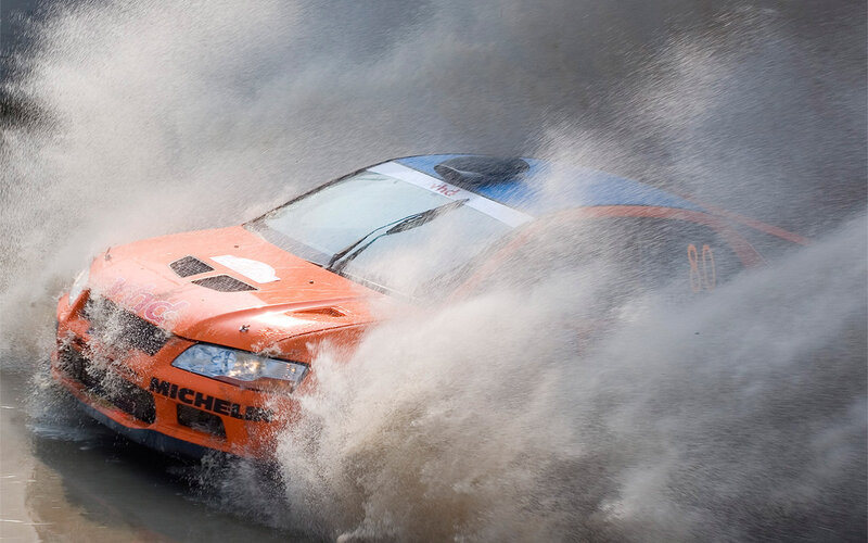 Racing car splashing through water
