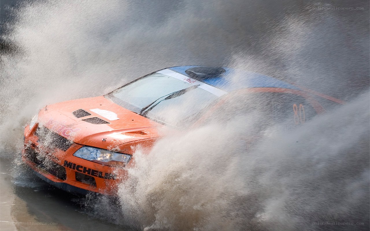 Racing car splashing through water