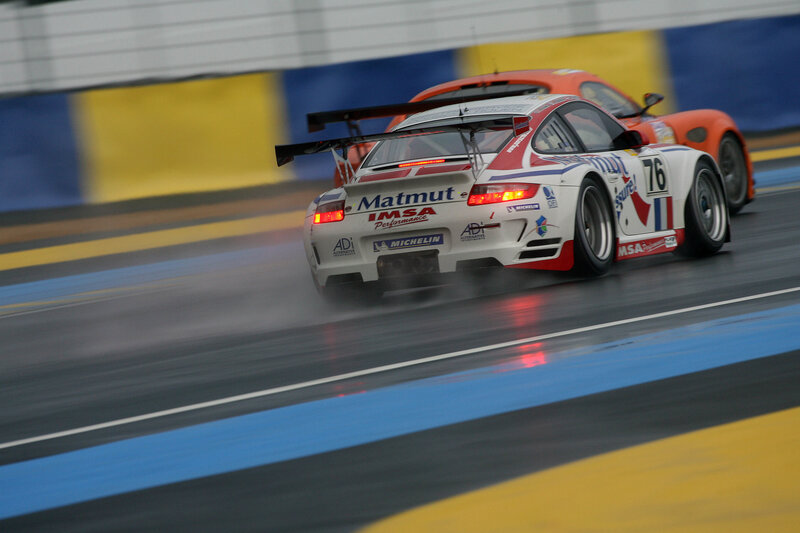 racing cars on a wet track