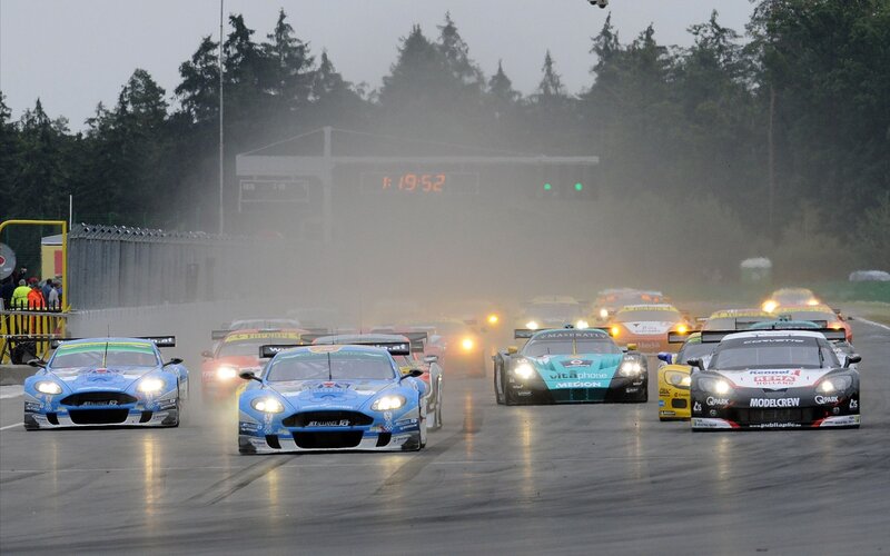 racing cars on a wet track