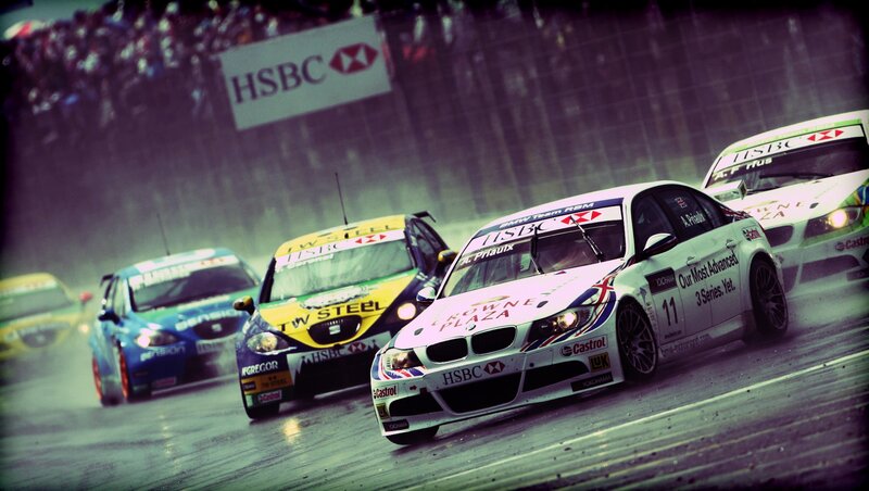 racing cars on a wet track