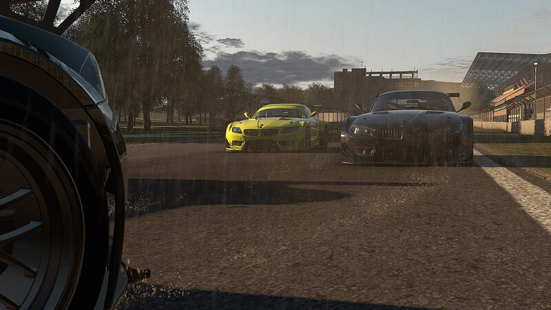racing cars on a wet track