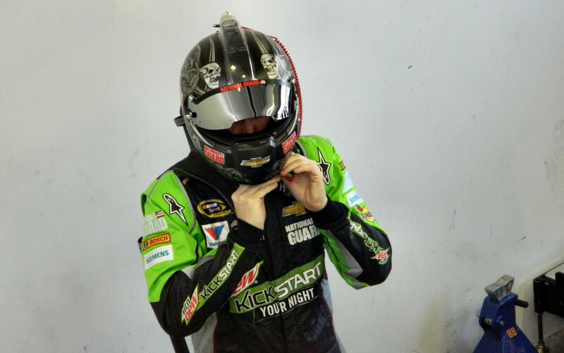 Racing Driver Adjusting Helmet
