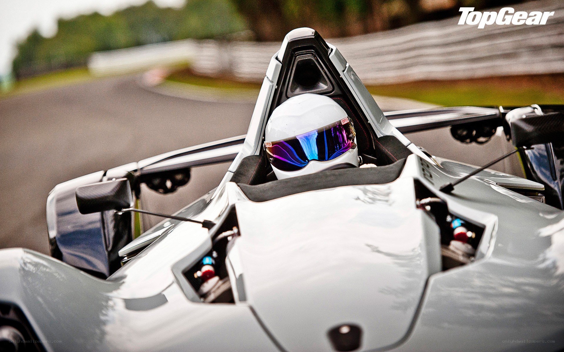 racing driver in a track car