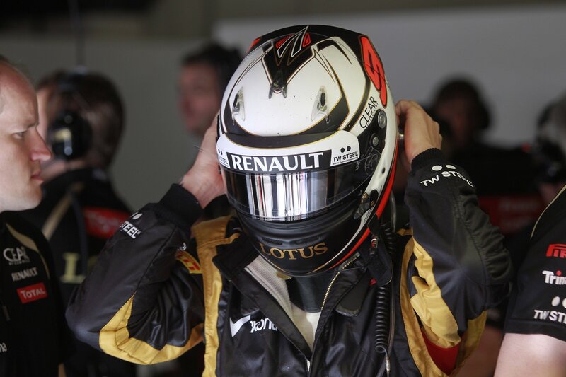 racing driver putting on helmet