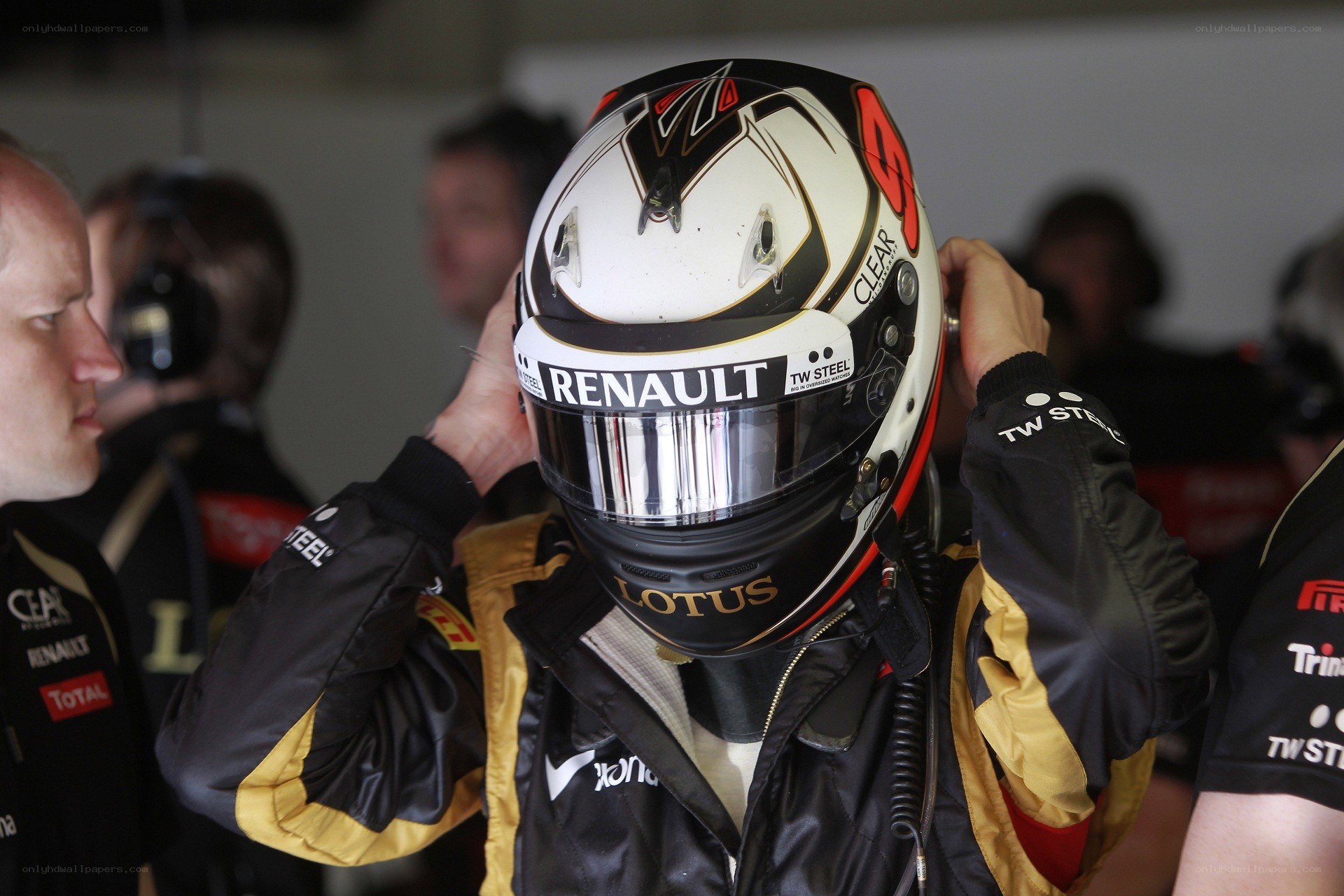 racing driver putting on helmet