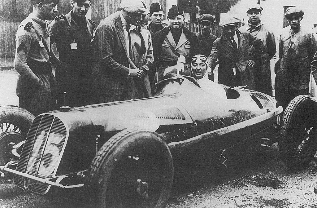 Racing driver with car and crew