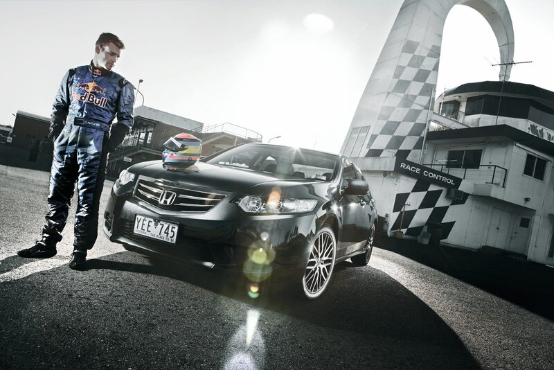 racing driver with car at track