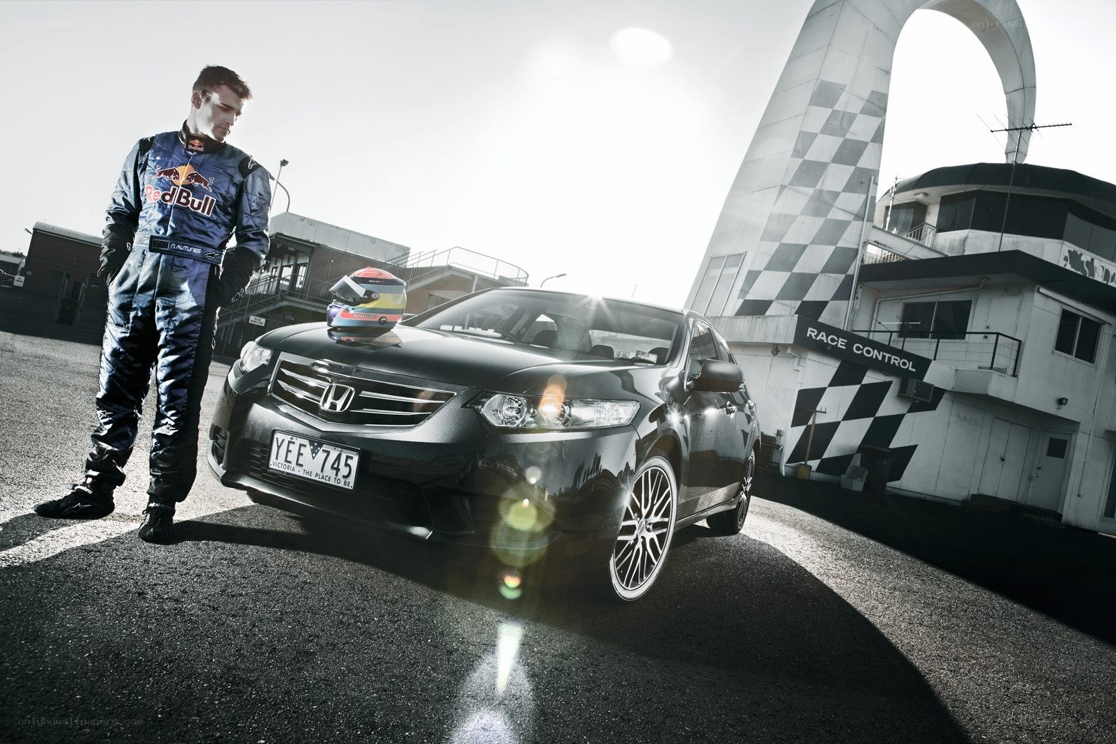 racing driver with car at track