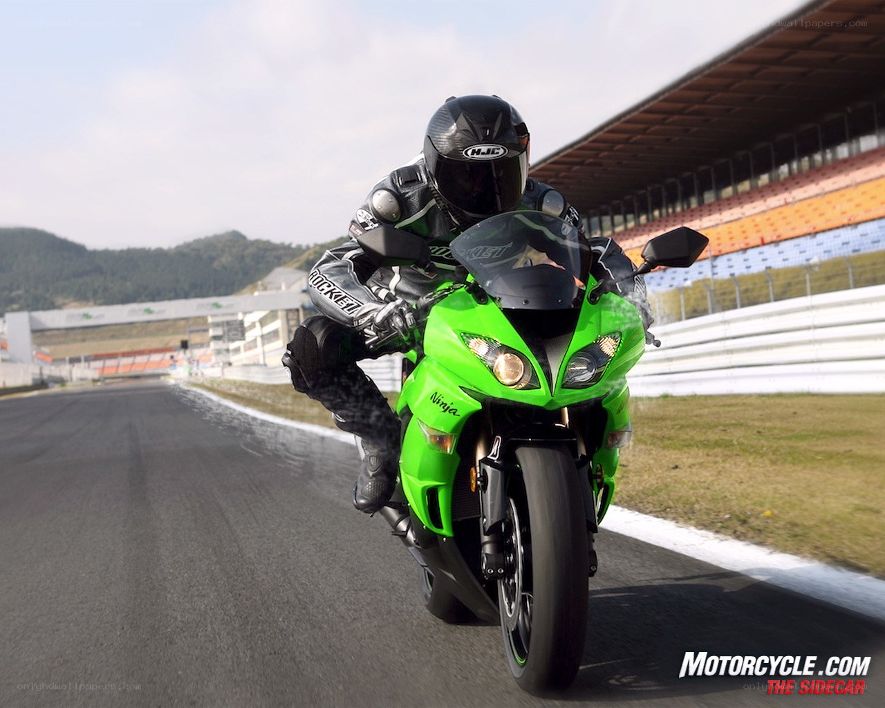 Racing green motorcycle on track