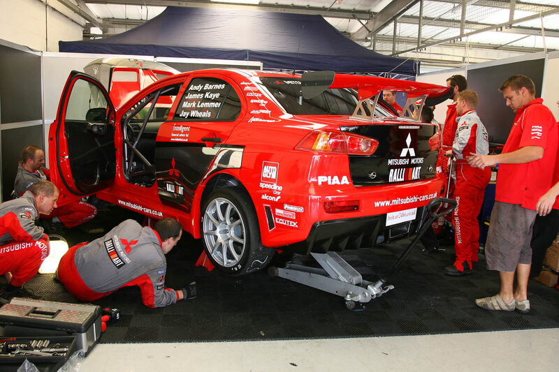 Racing team working on a car