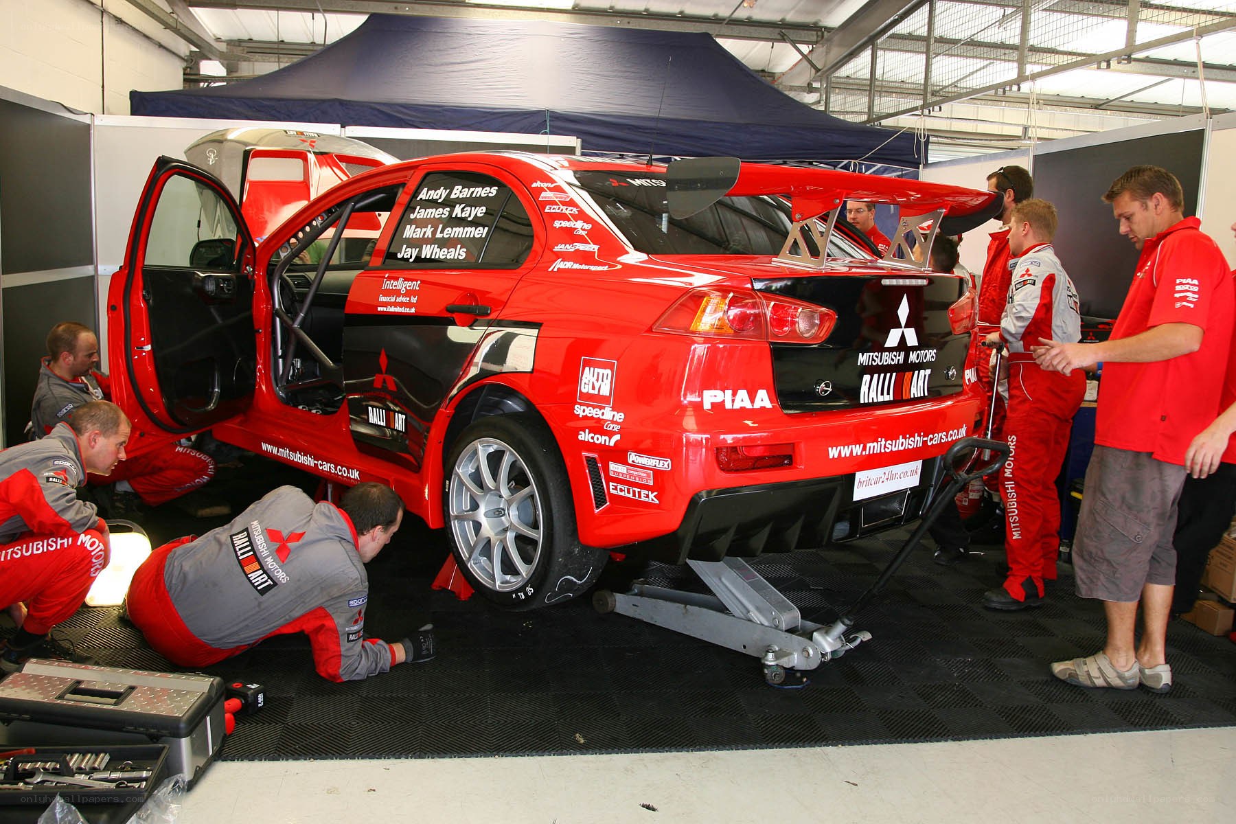 Racing team working on a car