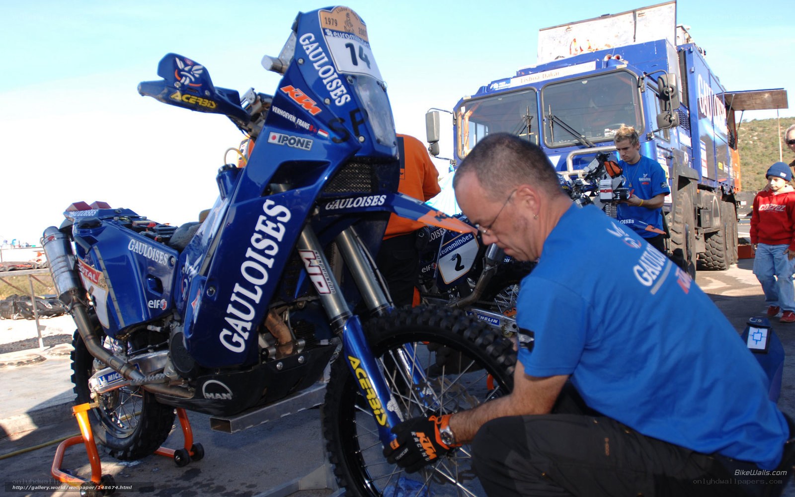 Racing team working on motorcycle