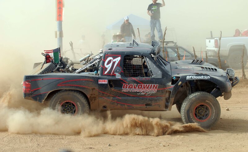 Racing truck kicking up dust