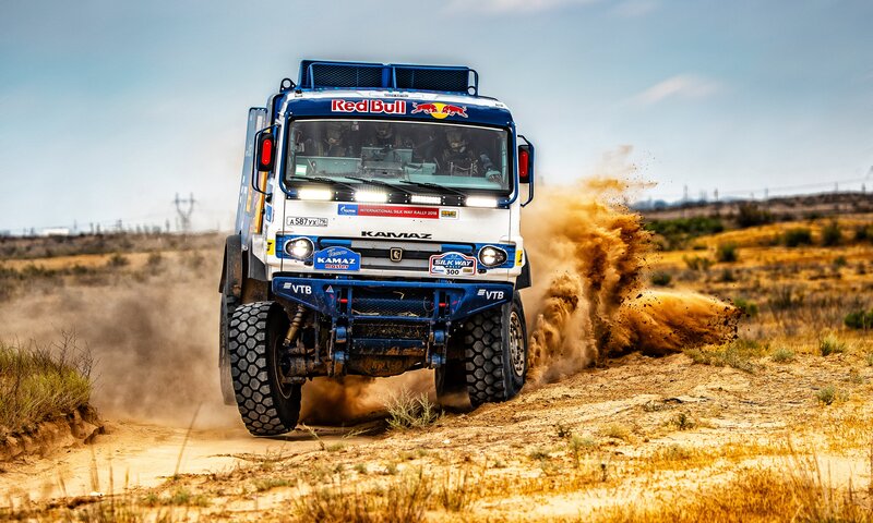 Racing Truck Kicking Up Dust — Blue, Dynamic