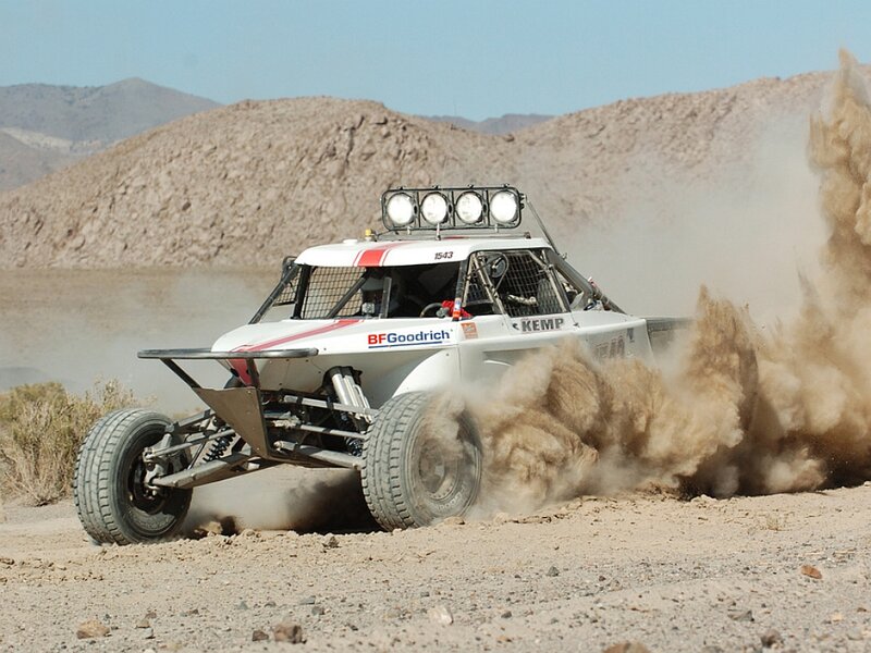 Racing Truck Kicking Up Dust — Brown, Dynamic