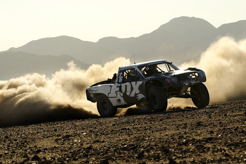Racing Truck Kicking Up Dust — Brown