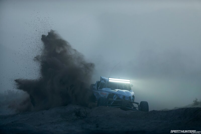Racing vehicle kicking up dust