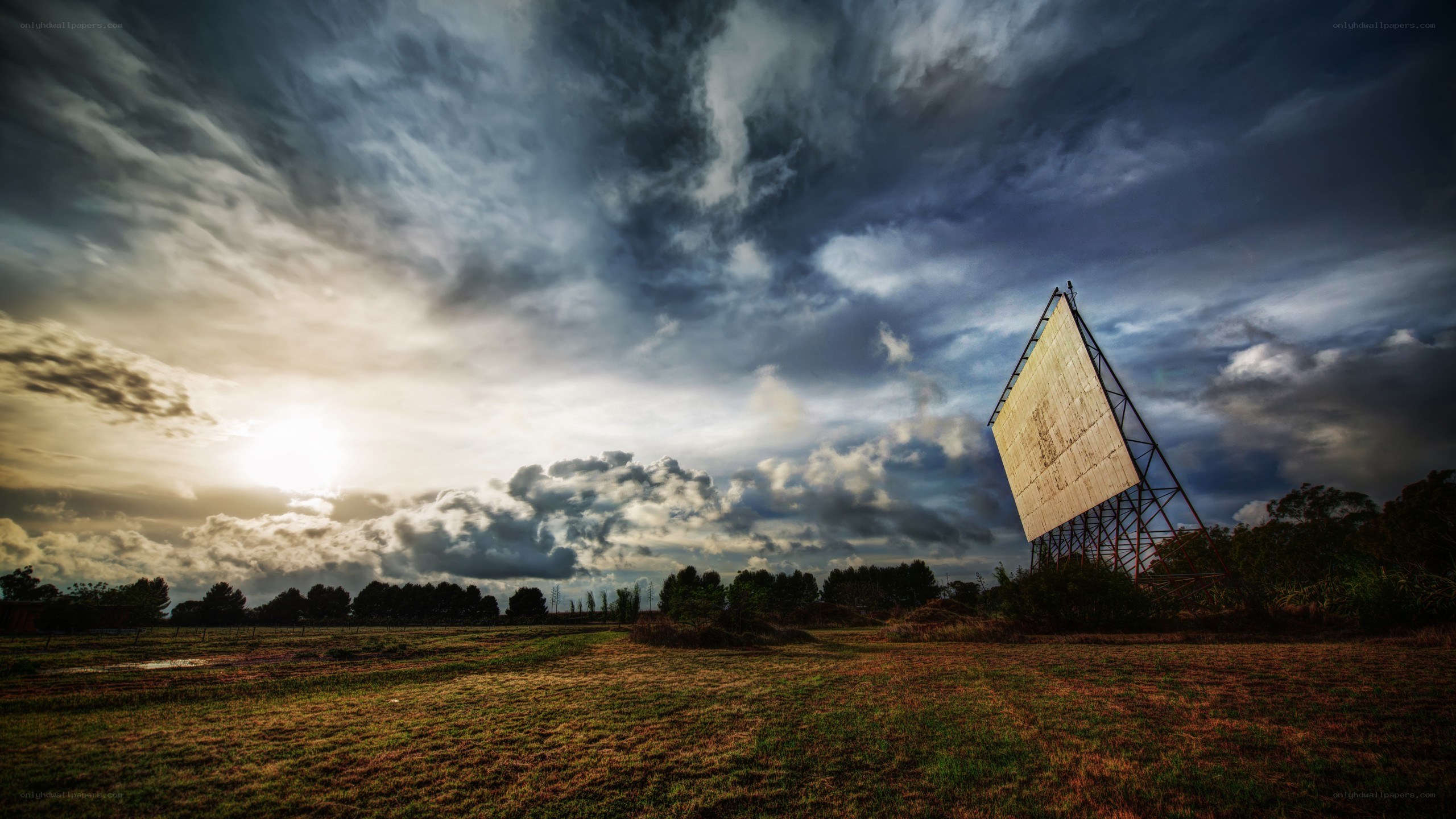 Radar dish in a field at sunset