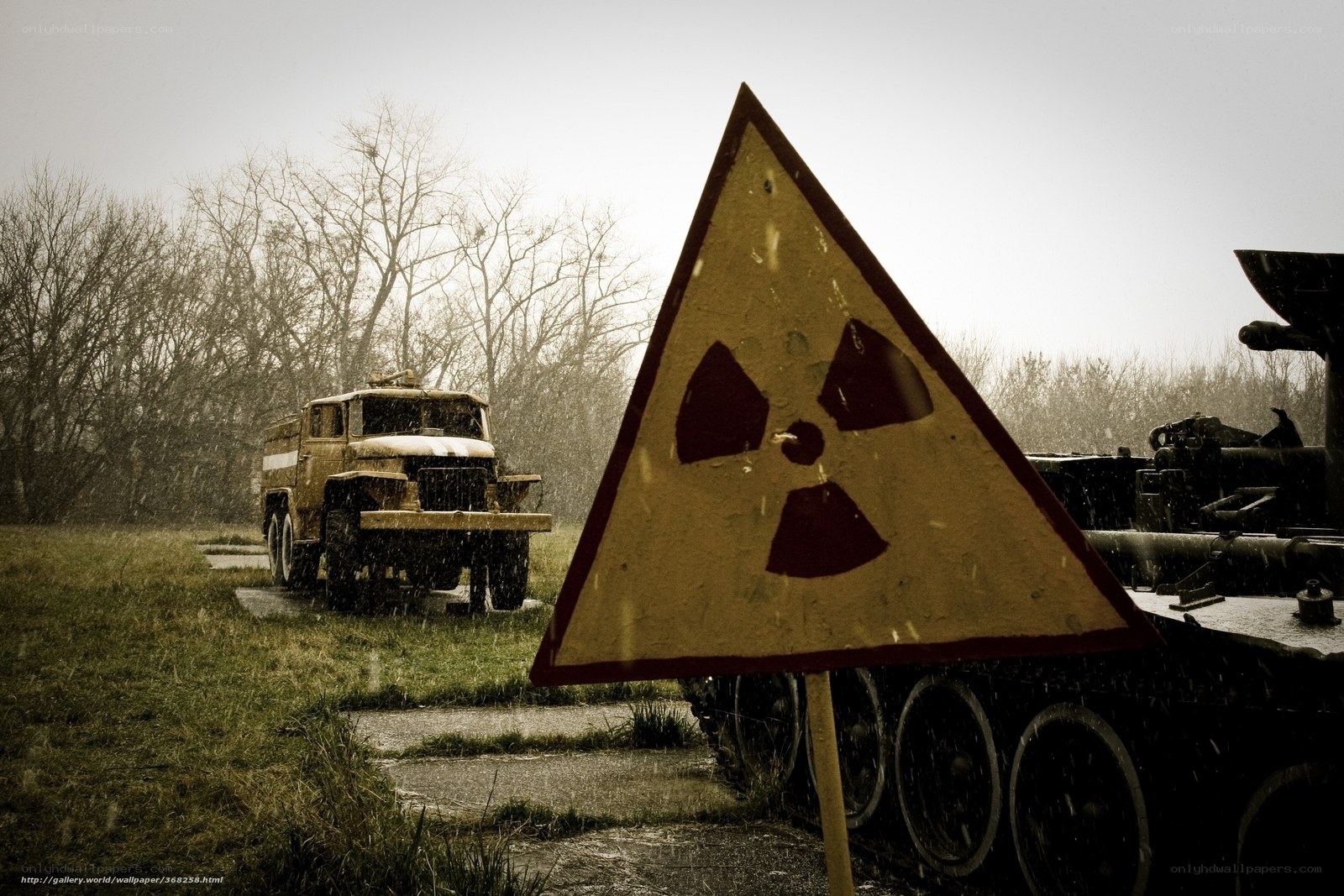 Radiation warning sign with military vehicles