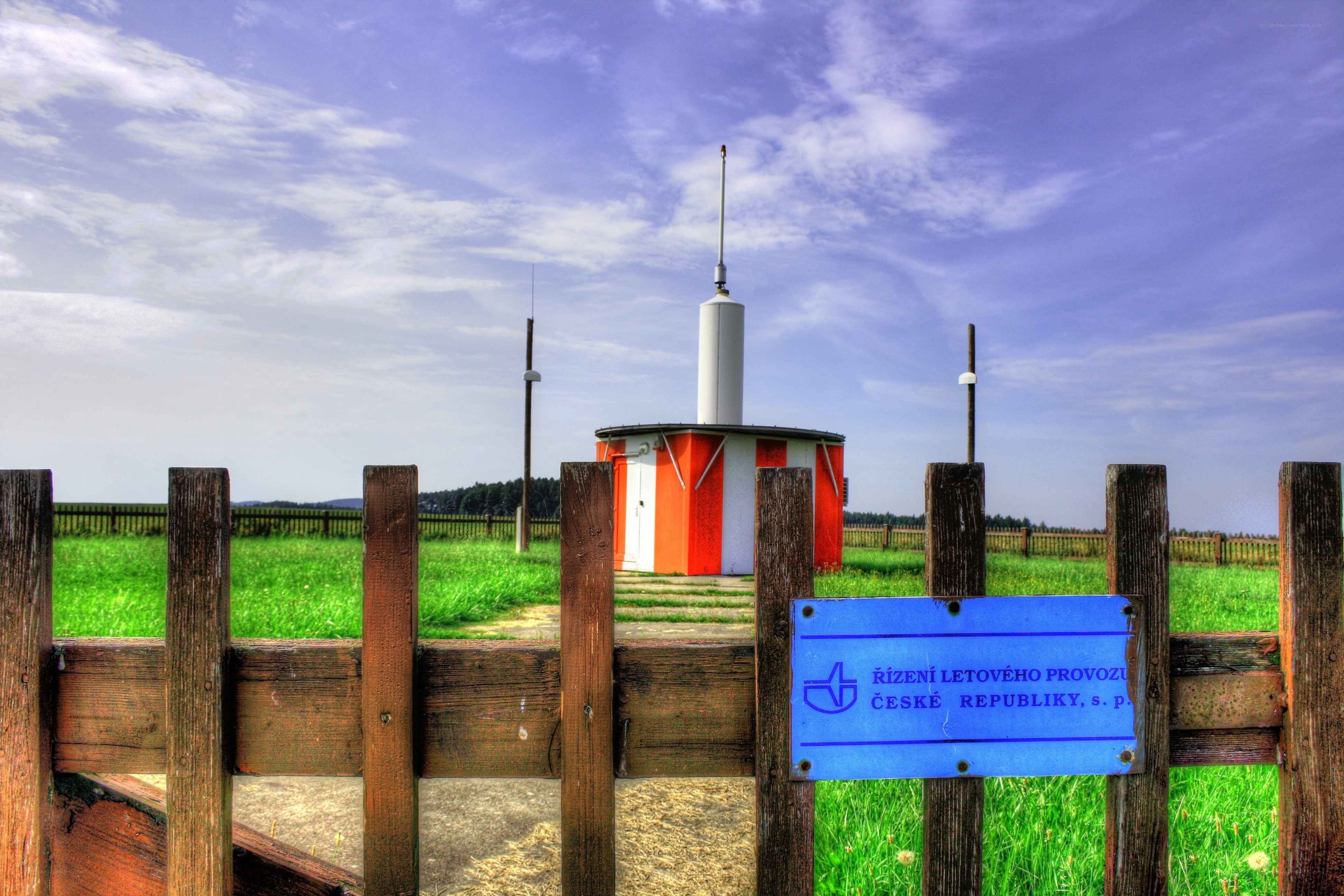 Radio tower in a green field