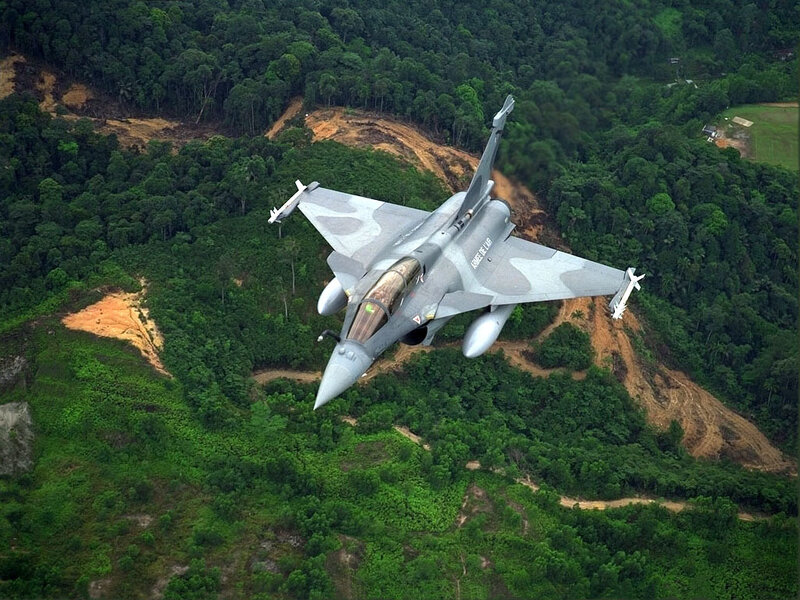 Rafale fighter jet over forest