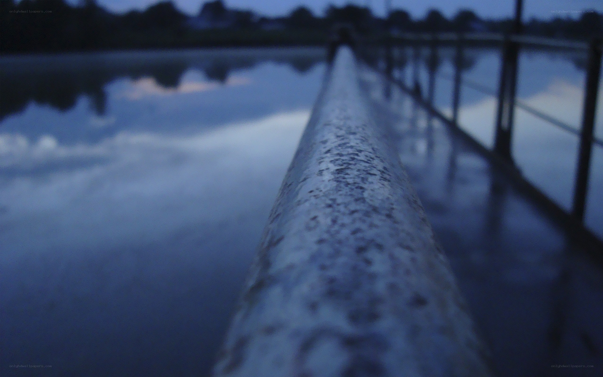 rail on a bridge at dusk