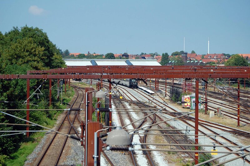 Rail yard with train and overhead lines