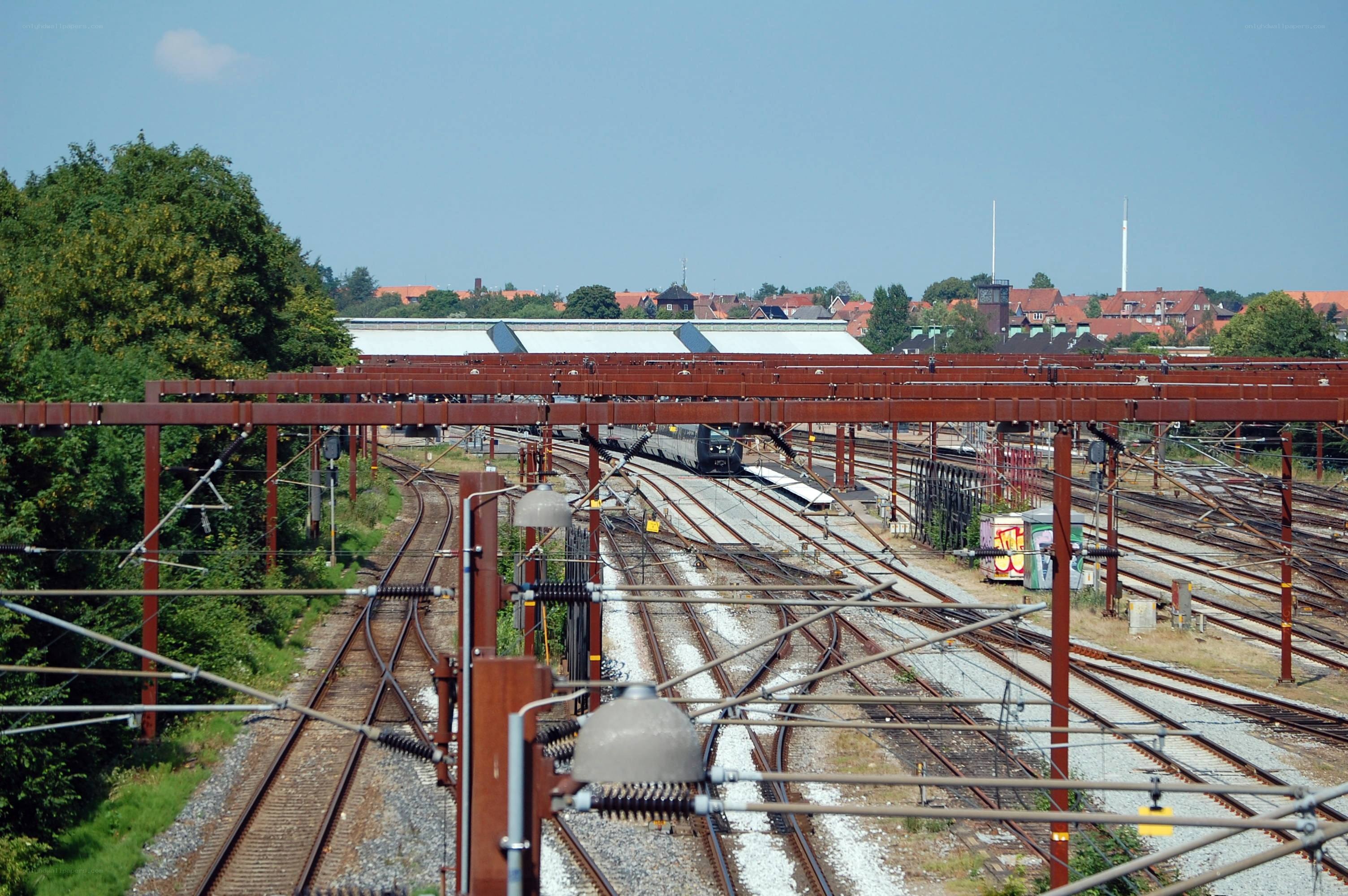 Rail yard with train and overhead lines