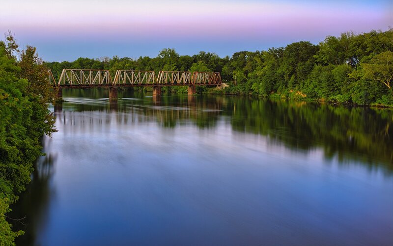 Railroad Bridge over River — Blue, Serene, Sunset, Photograph, Trees