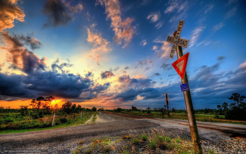Railroad crossing at sunset