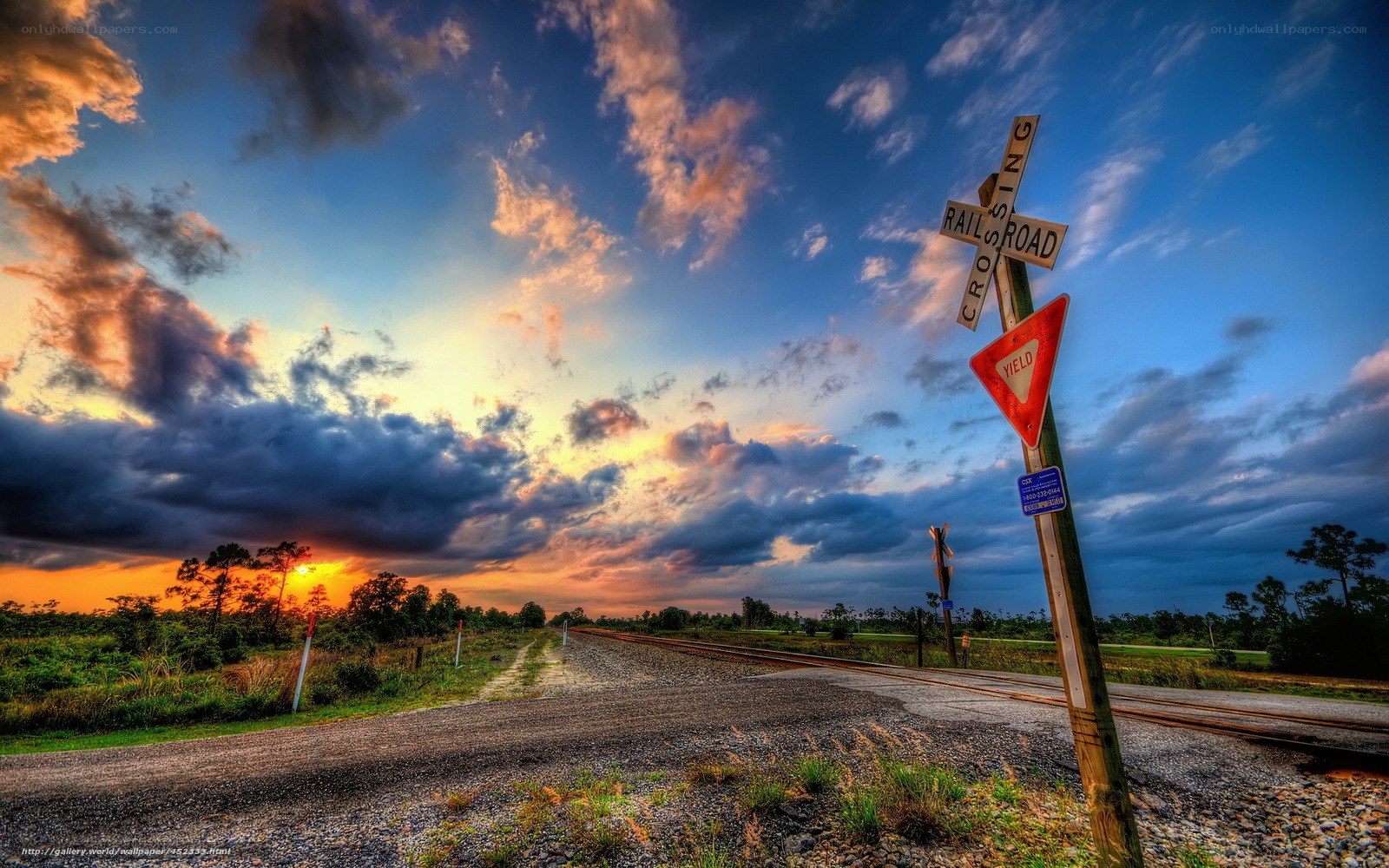 Railroad crossing at sunset