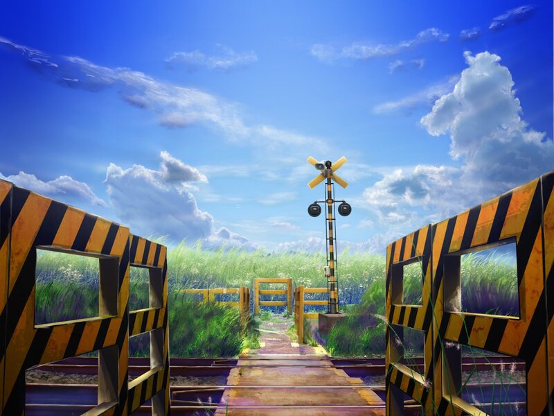 Railroad crossing in a sunny field