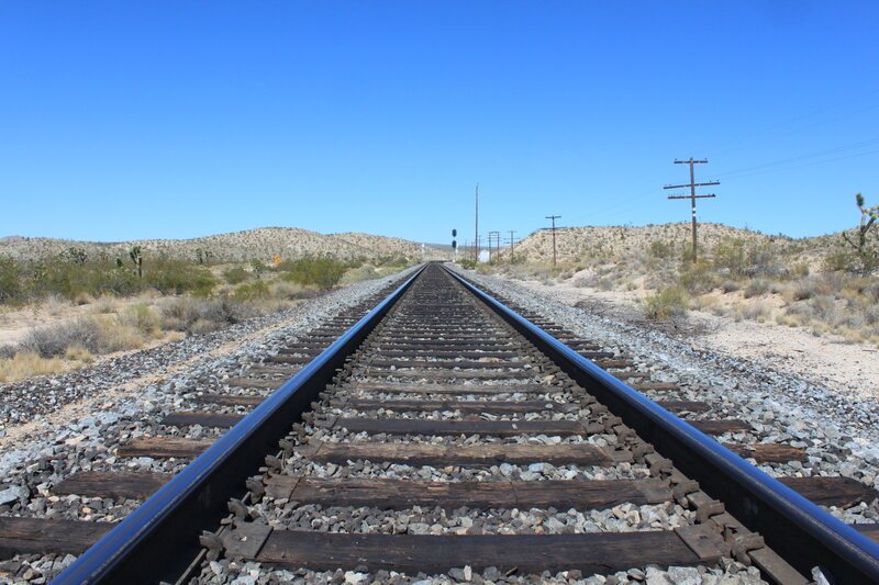 Railroad Tracks in Desert — Blue, Desolate